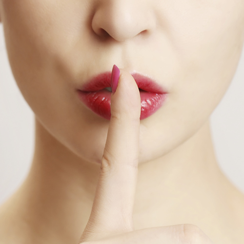 woman-hushing-with-finger-on-lips_500x500