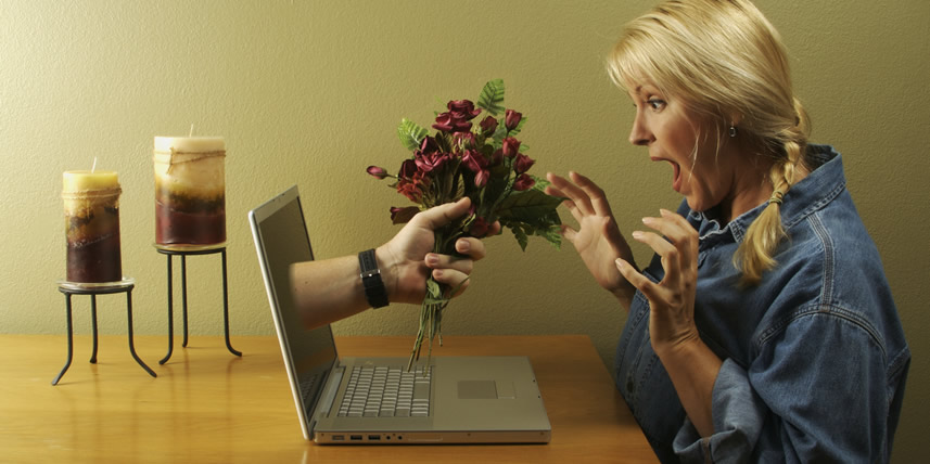 blonde-woman-receiving-flowers-from-man-through-laptop