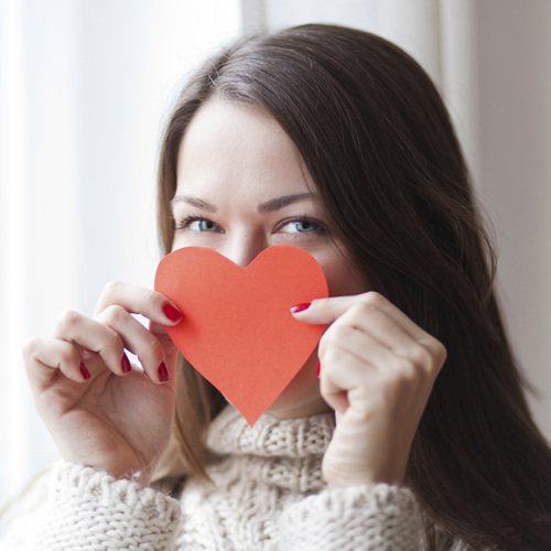 brunette-covering-her-face-with-red-heart_500x500