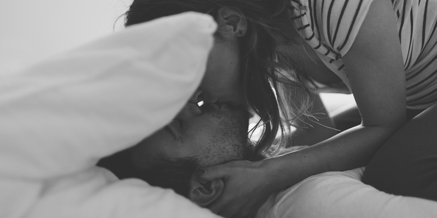 man-and-woman-kissing-in-bed