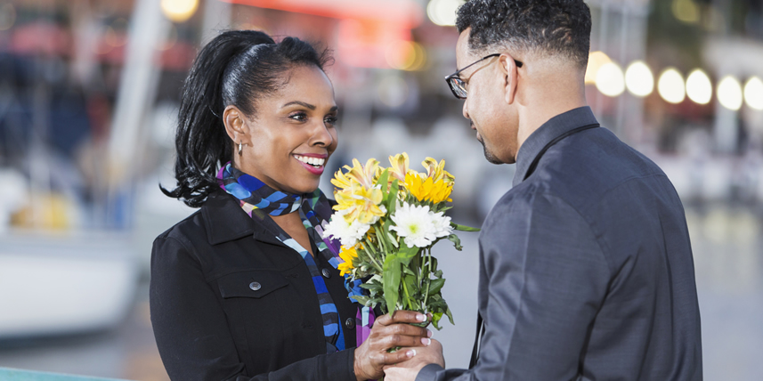 man-giving-flowers-to-young-latino-woman