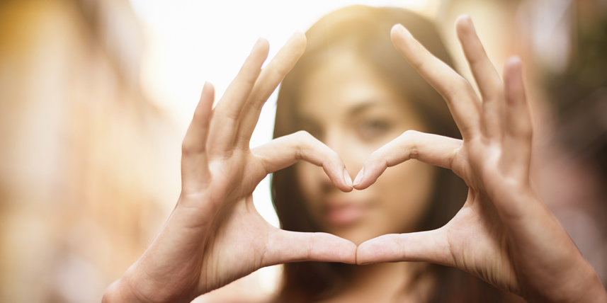 young-brunette-forms-heart-shape-with-her-fingers