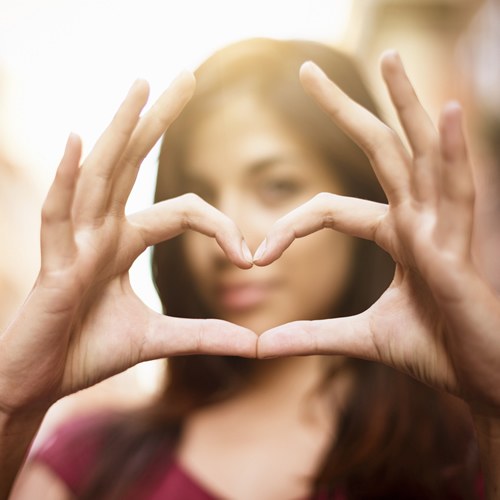 young-brunette-forms-heart-shape-with-her-fingers_500x500